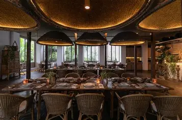 Serene riverside suite at Raya Heritage Chiang Mai featuring handcrafted Lanna furniture